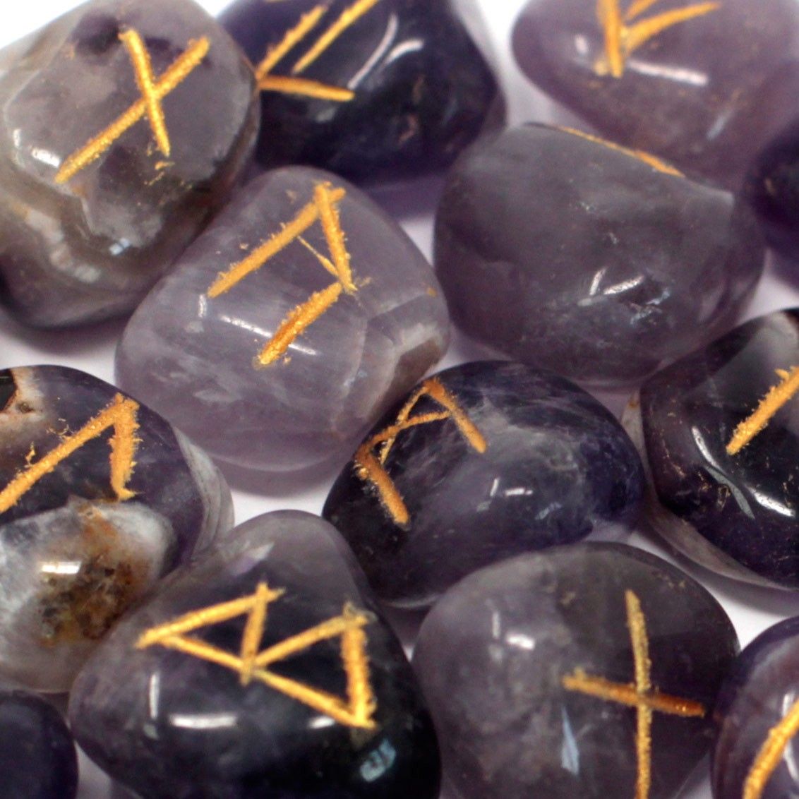 Natural Amethyst rune set with 25 engraved crystal stones and black storage pouch for divination, meditation and spiritual practice.