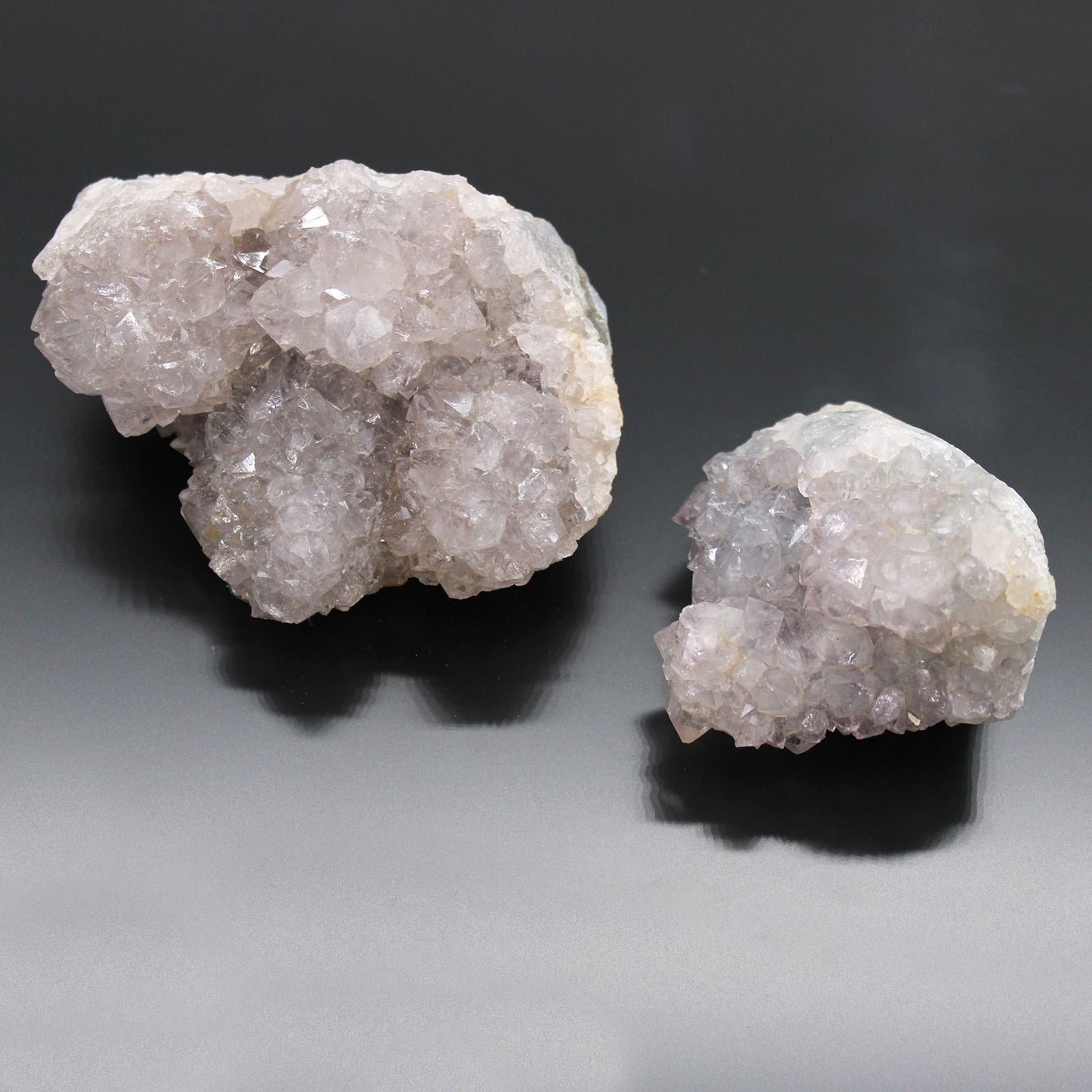 Two crystal formations on a gradient gray background