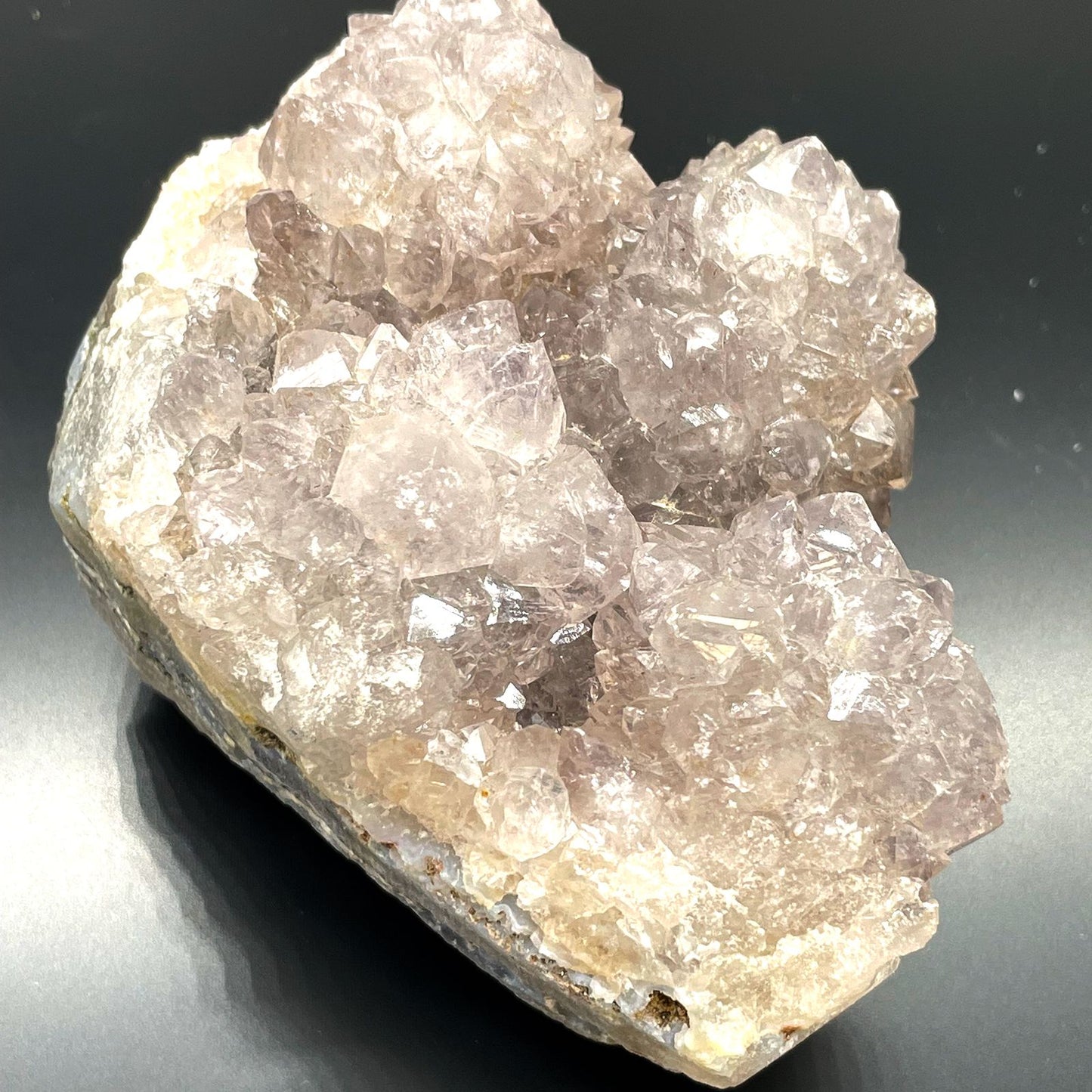 Crystal rock on a reflective surface with a dark background