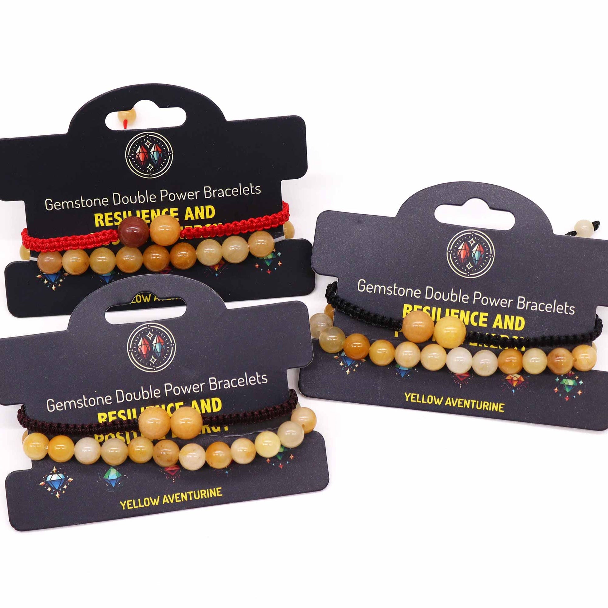 Three gemstone double power bracelets on display with packaging on a white background
